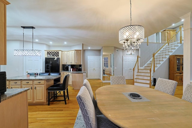 dining room with a chandelier and light wood-type flooring