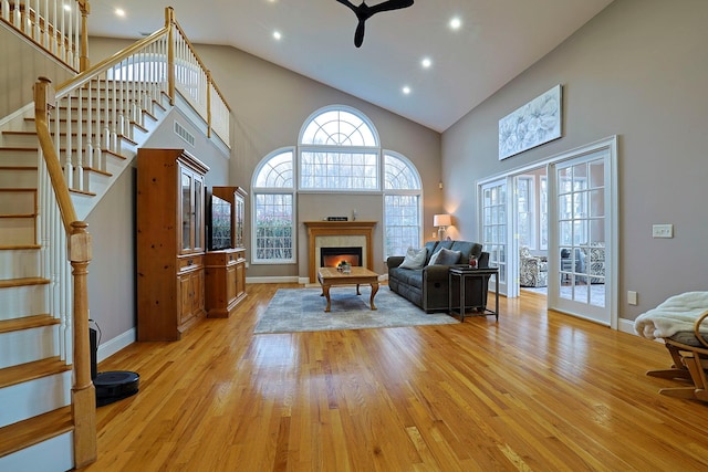 living room featuring french doors, high vaulted ceiling, light hardwood / wood-style flooring, and ceiling fan