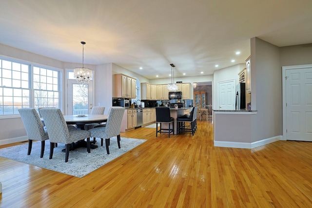 dining room featuring a chandelier and light wood-type flooring