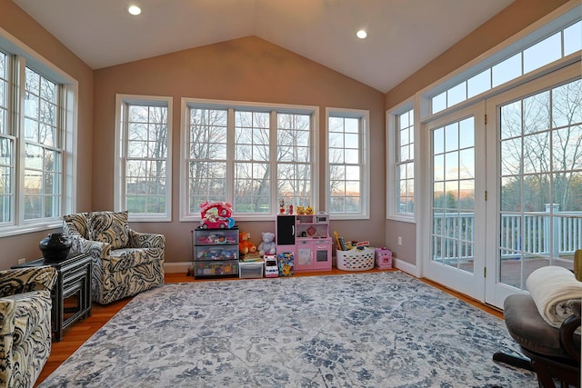 sunroom / solarium with a healthy amount of sunlight and vaulted ceiling