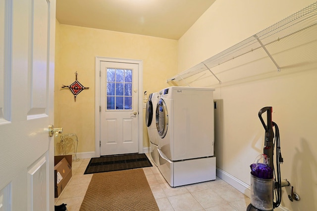 washroom featuring independent washer and dryer and light tile patterned floors