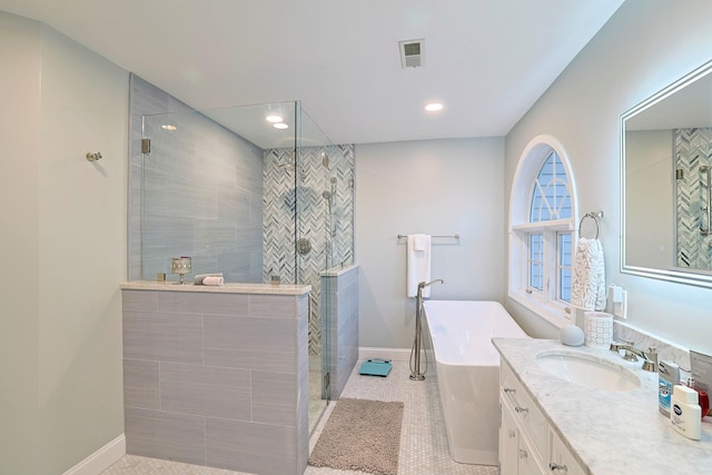 bathroom with tile patterned floors, vanity, and independent shower and bath