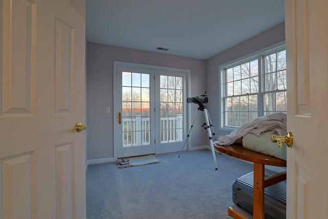 doorway to outside with carpet flooring