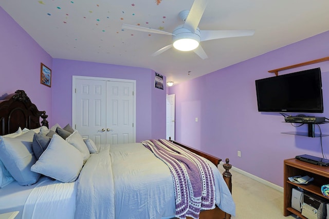 carpeted bedroom with ceiling fan and a closet