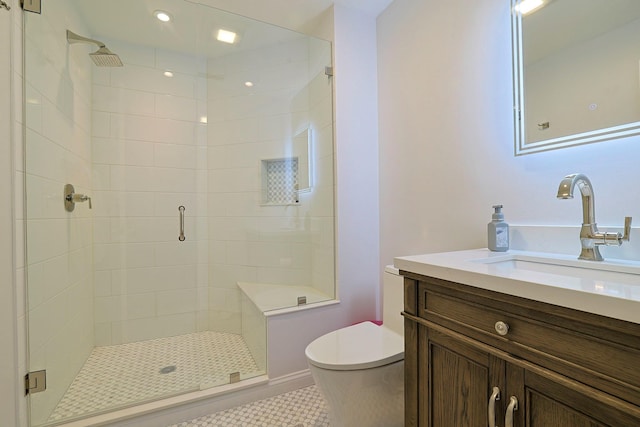 bathroom with tile patterned flooring, vanity, toilet, and walk in shower