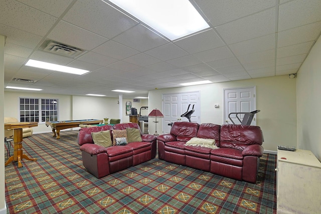 carpeted living room featuring a drop ceiling and pool table