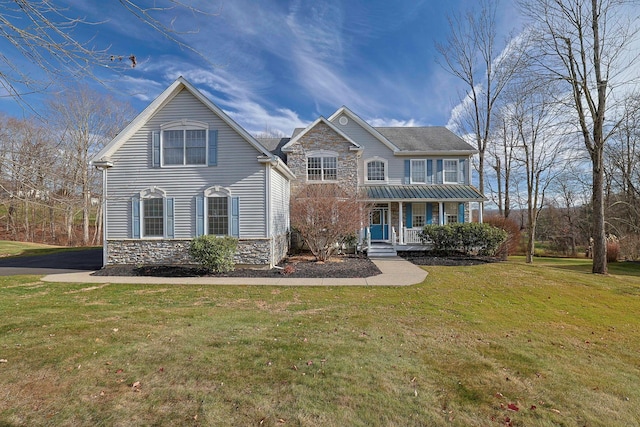 view of front of property with covered porch and a front lawn