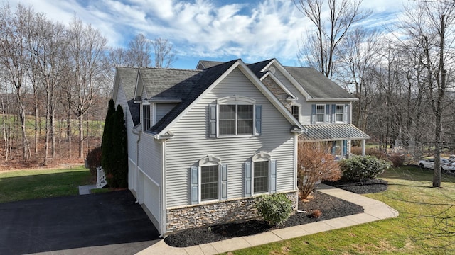 view of home's exterior with a yard and a garage