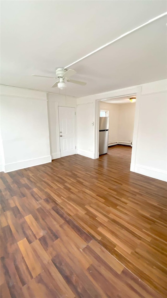 unfurnished living room with ceiling fan and dark hardwood / wood-style flooring