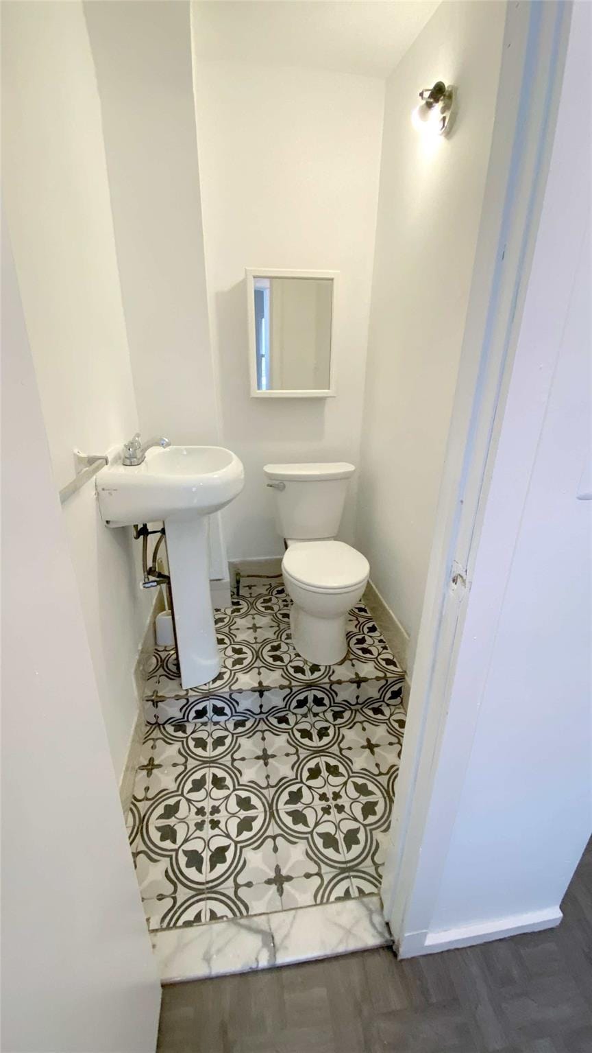 bathroom with sink, tile patterned floors, and toilet