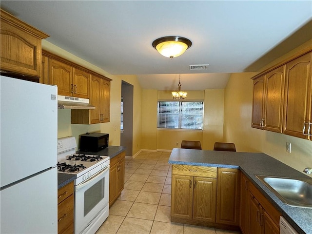 kitchen featuring sink, a chandelier, decorative light fixtures, white appliances, and light tile patterned floors