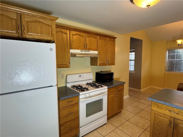 kitchen featuring light tile patterned floors and white appliances