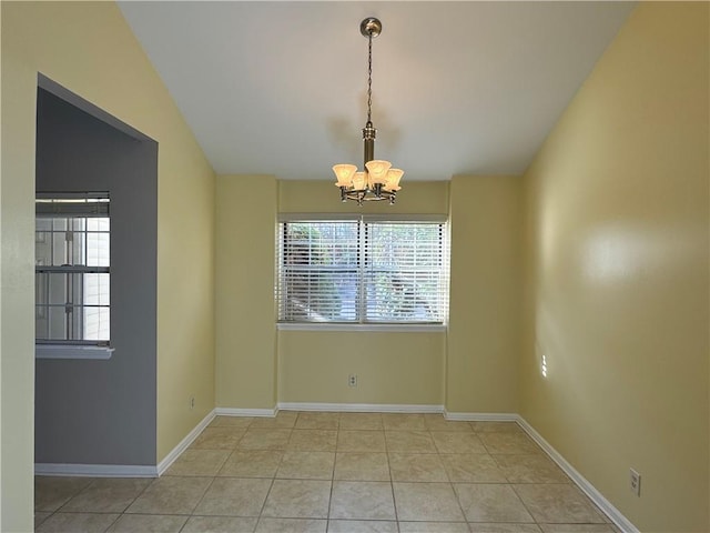 unfurnished dining area featuring a chandelier, light tile patterned floors, and vaulted ceiling