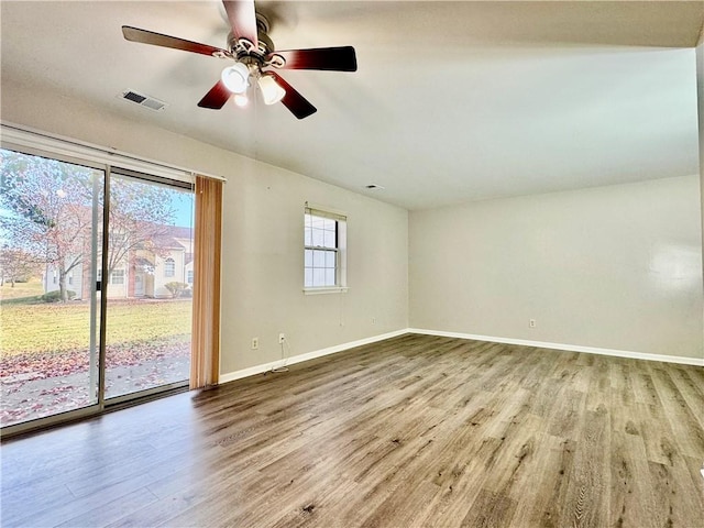 spare room with hardwood / wood-style floors and ceiling fan