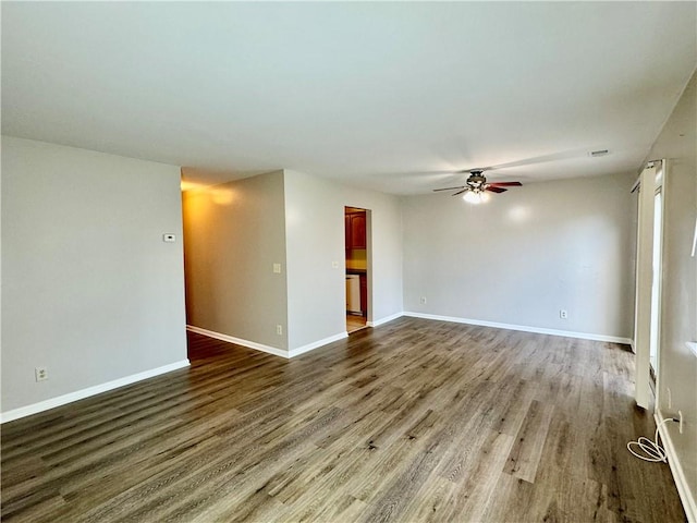 unfurnished living room with dark hardwood / wood-style floors and ceiling fan