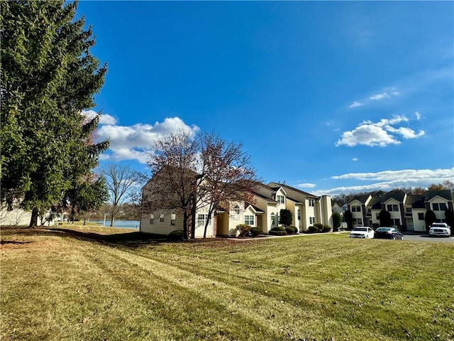 view of side of property with a yard