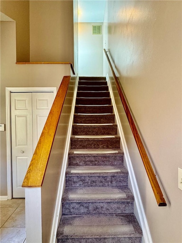 stairway featuring tile patterned floors