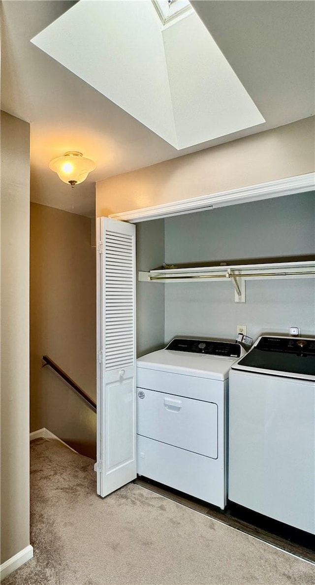 laundry area featuring washer and dryer and light carpet