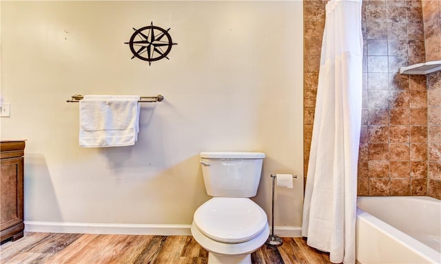 full bathroom with vanity, hardwood / wood-style flooring, toilet, and shower / bath combo with shower curtain