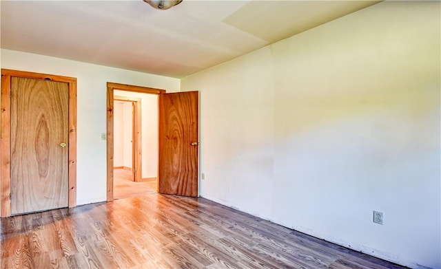 unfurnished bedroom featuring wood-type flooring