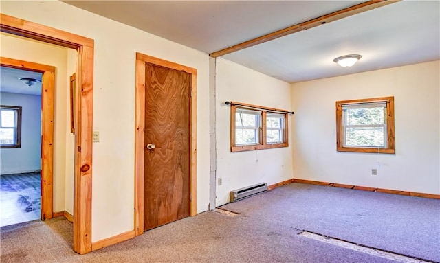 interior space featuring light colored carpet and a baseboard radiator