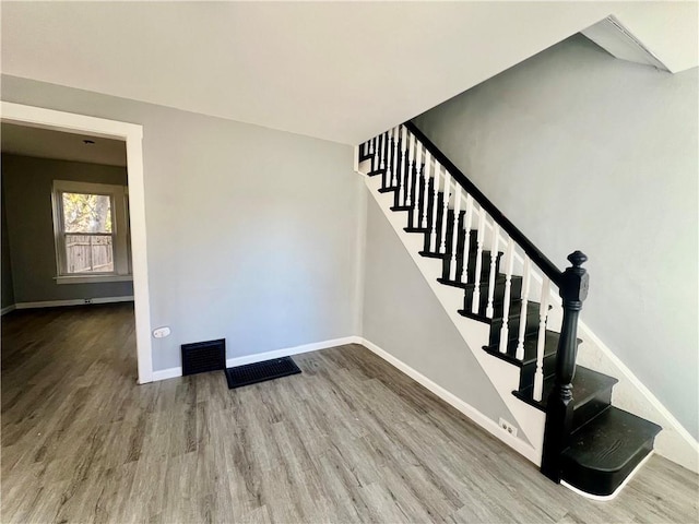 staircase featuring wood-type flooring