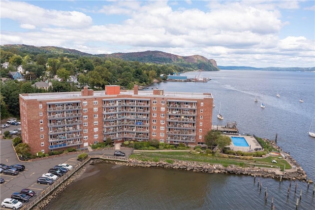 drone / aerial view featuring a water and mountain view