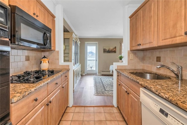 kitchen with white dishwasher, crown molding, sink, gas stovetop, and light stone counters