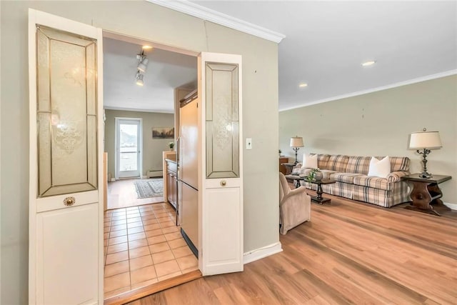 kitchen featuring crown molding, light hardwood / wood-style flooring, and a baseboard heating unit