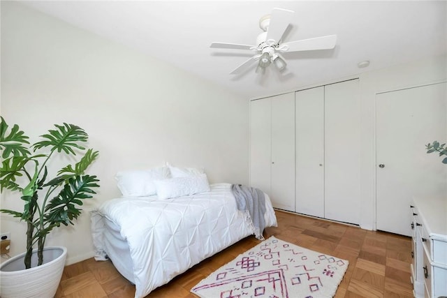 bedroom with light parquet flooring, a closet, and ceiling fan