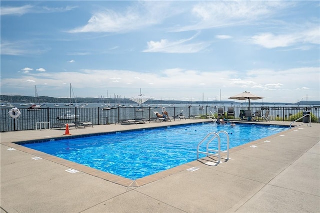 view of pool with a water view