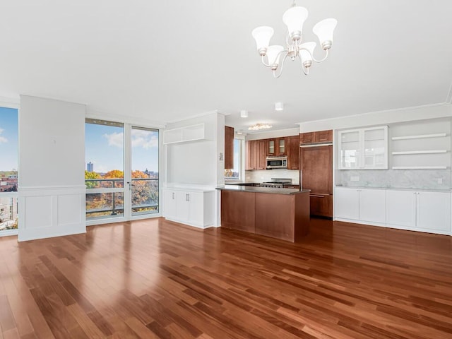 kitchen featuring a chandelier, appliances with stainless steel finishes, dark hardwood / wood-style floors, and tasteful backsplash