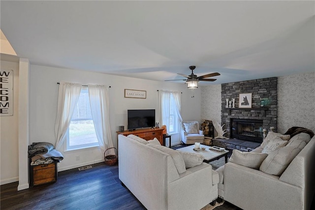 living room featuring a fireplace, dark hardwood / wood-style floors, and ceiling fan