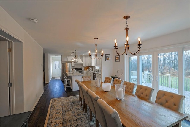 dining room with a chandelier and dark hardwood / wood-style flooring