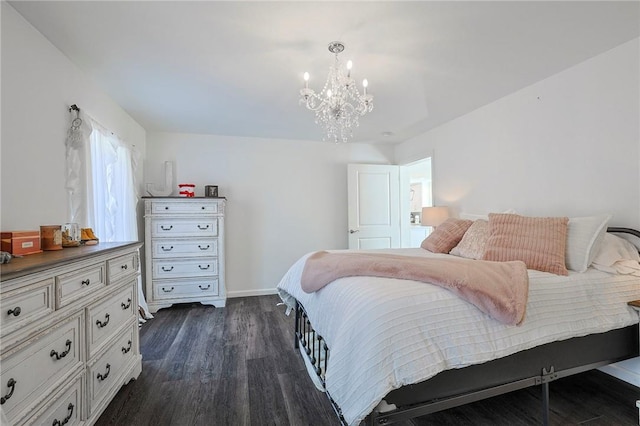 bedroom with dark wood-type flooring and an inviting chandelier