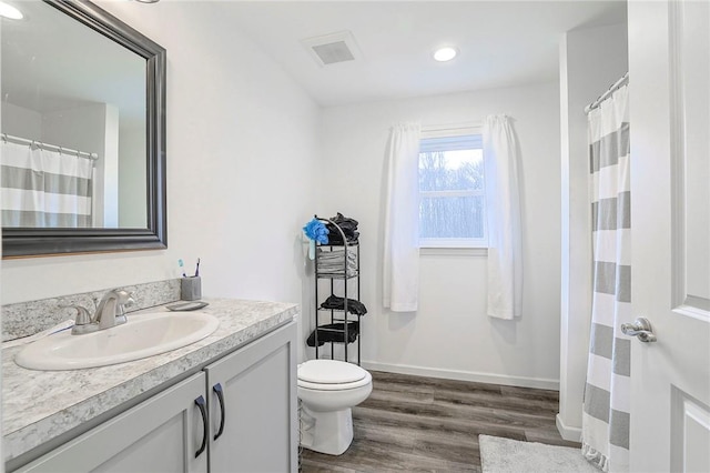 bathroom featuring hardwood / wood-style floors, vanity, and toilet