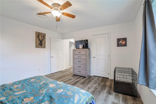 bedroom with hardwood / wood-style floors and ceiling fan