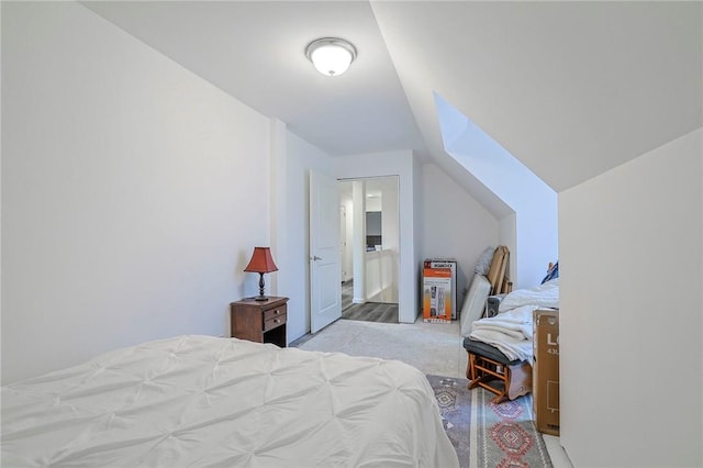 carpeted bedroom featuring lofted ceiling