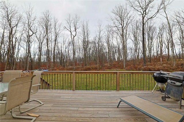 wooden terrace with area for grilling and a lawn