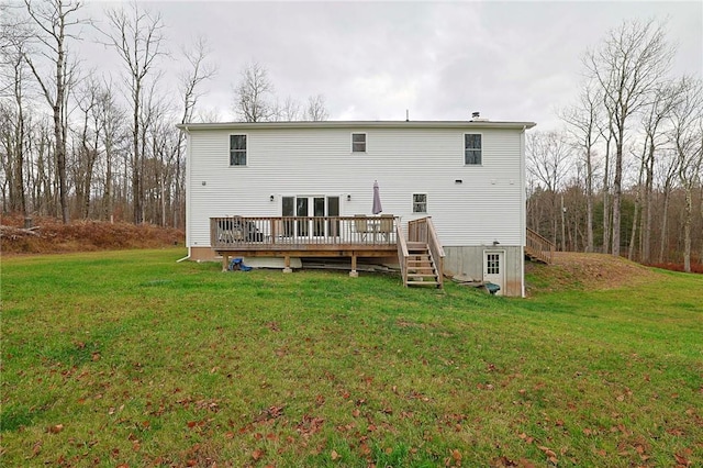 back of house with a deck and a lawn