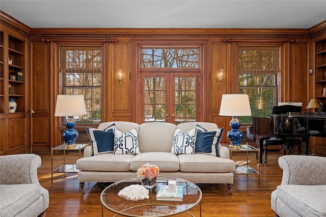 living room featuring a healthy amount of sunlight, wood finished floors, and french doors