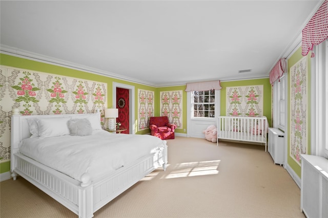 bedroom featuring carpet floors, radiator heating unit, visible vents, and crown molding