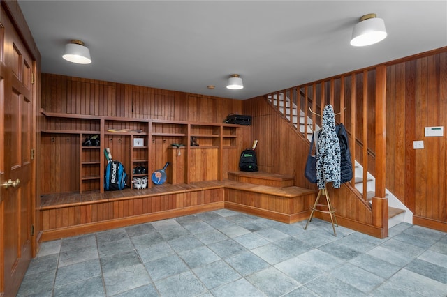 mudroom with wood walls