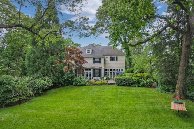 rear view of house with a lawn