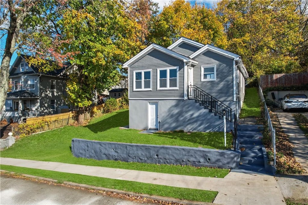 exterior space with fence and a yard