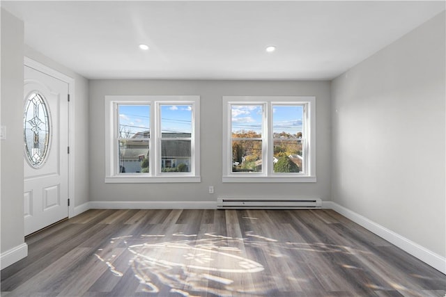 entrance foyer featuring dark hardwood / wood-style floors, a healthy amount of sunlight, and a baseboard radiator