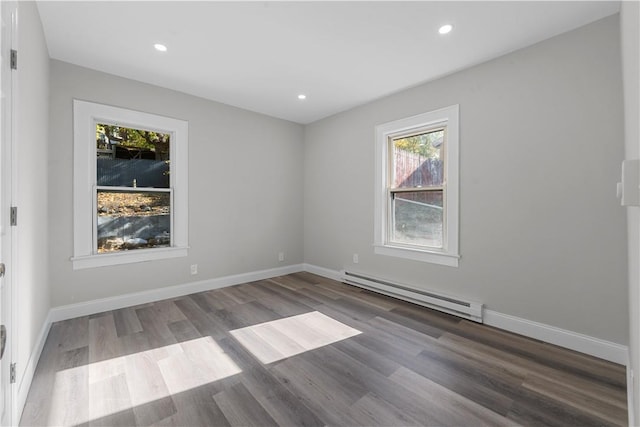 spare room featuring hardwood / wood-style floors and baseboard heating