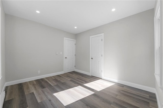 empty room with dark hardwood / wood-style flooring