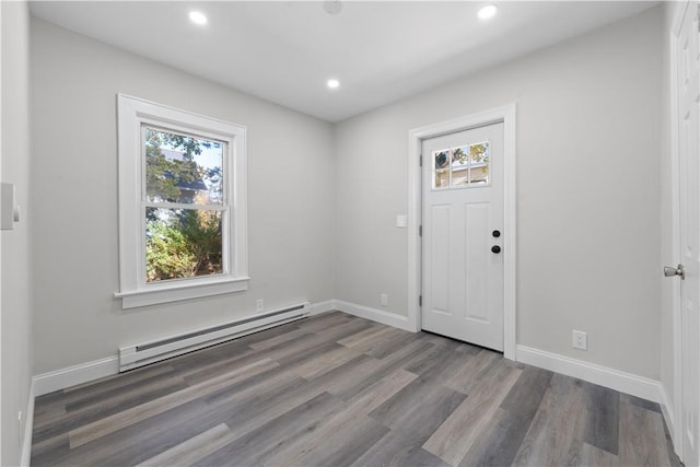 entryway featuring hardwood / wood-style flooring and a baseboard heating unit