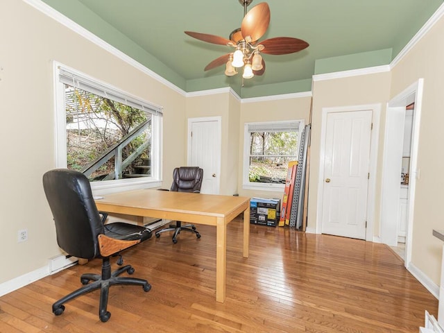 home office featuring hardwood / wood-style flooring, a wealth of natural light, crown molding, and ceiling fan